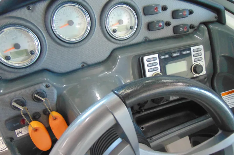 Slide: The Image of Dashboard of a 2014 Yamaha AR210 boat with gauges and controls. - 17