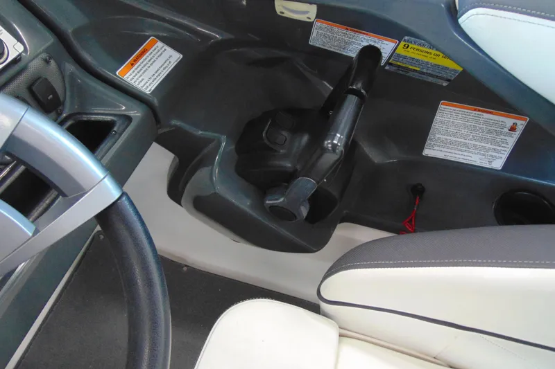 Slide: The Image of 2014 Yamaha AR210 boat cockpit with steering wheel and control panel. - 18