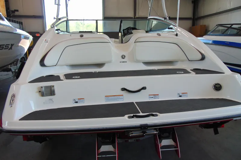 Slide: The Image of 2014 Yamaha Boats AR210 rear view in a showroom setting. - 5