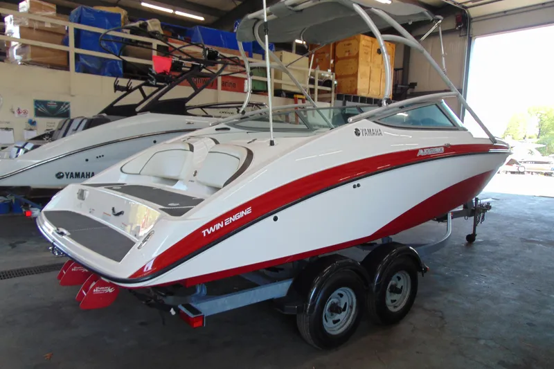 Slide: The Image of 2014 Yamaha AR210 boat with twin engines on a trailer in a garage. - 7