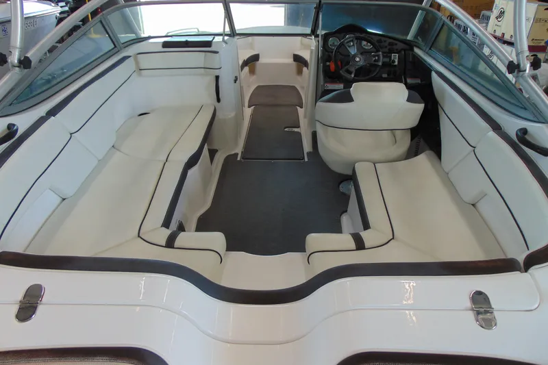 Slide: The Image of 2014 Yamaha Boats AR210 interior with white seating and steering console. - 8