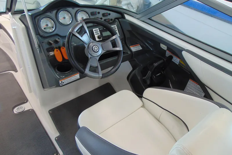 Slide: The Image of 2014 Yamaha AR210 boat cockpit with steering wheel and control panel. - 9