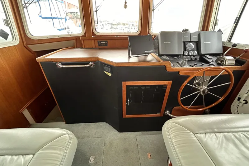 Slide: The Image of Pilothouse interior of 2003 American Tug 34 with steering wheel and navigation equipment. - 10