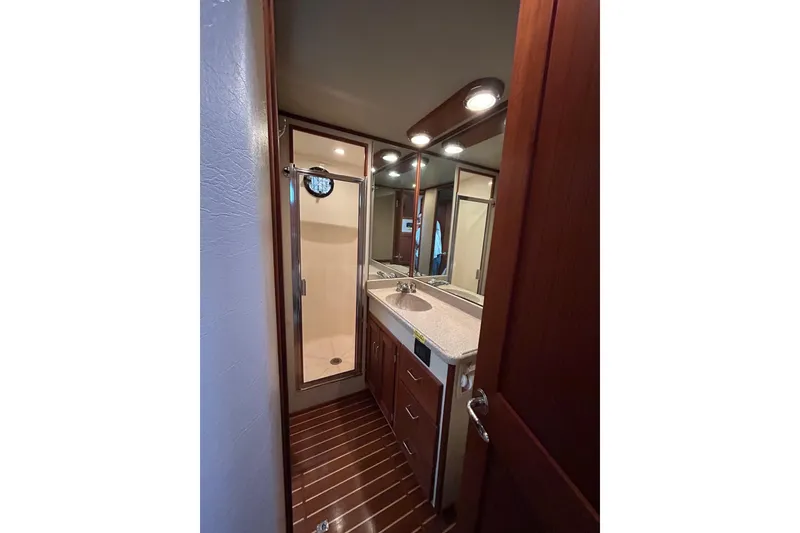 Slide: The Image of Bathroom interior of 2003 American Tug 34 with wood accents and modern fixtures. - 15