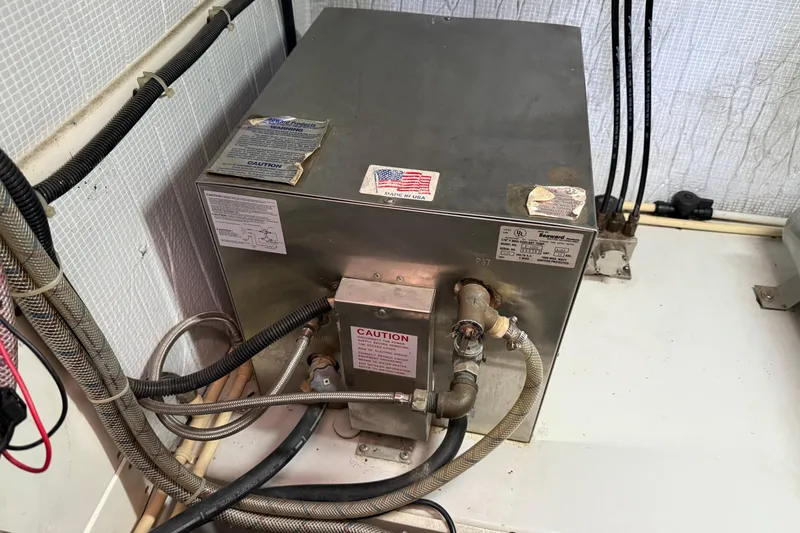 Slide: The Image of Engine room of a 2003 American Tug 34, featuring a Seaward water heater. - 17