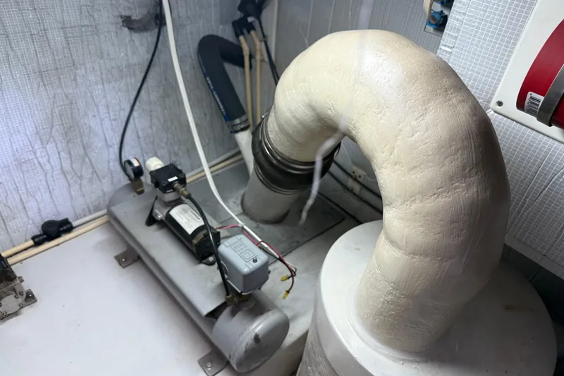 Slide: The Image of Engine room of a 2003 American Tug 34, featuring insulated piping and mechanical components. - 18