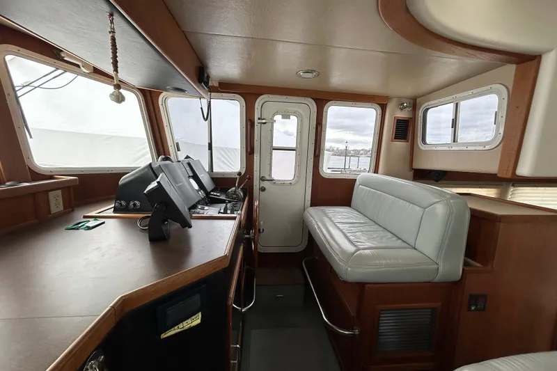 Slide: The Image of Interior of 2003 American Tug 34 with helm, seating, and navigation equipment. - 9