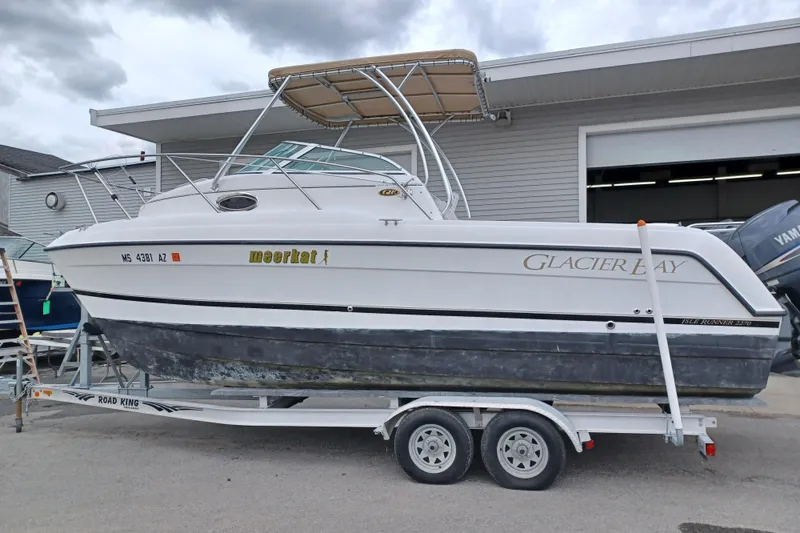 Slide: The Image of 2008 Glacier Bay 2270 Isle Runner boat on trailer, parked outside a building. - 1