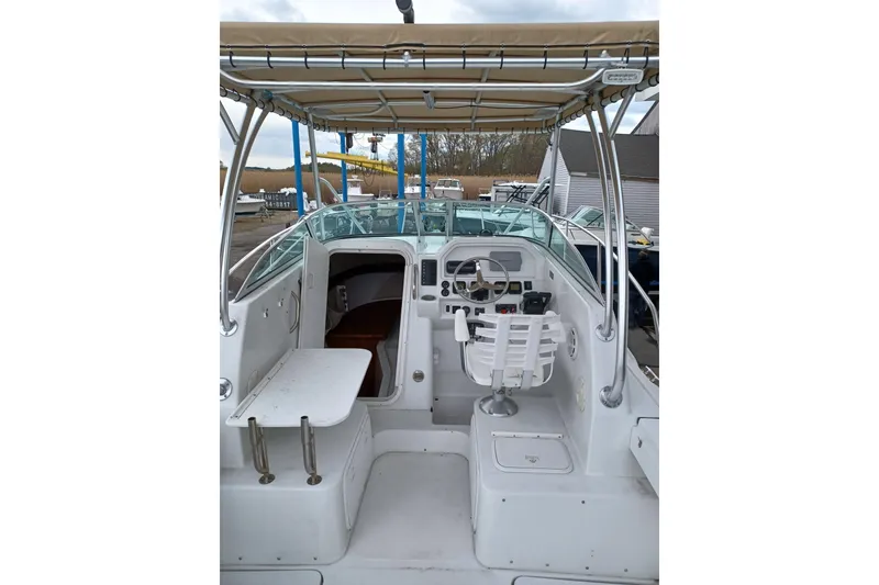 Slide: The Image of 2008 Glacier Bay 2270 Isle Runner boat interior with helm and seating area. - 10