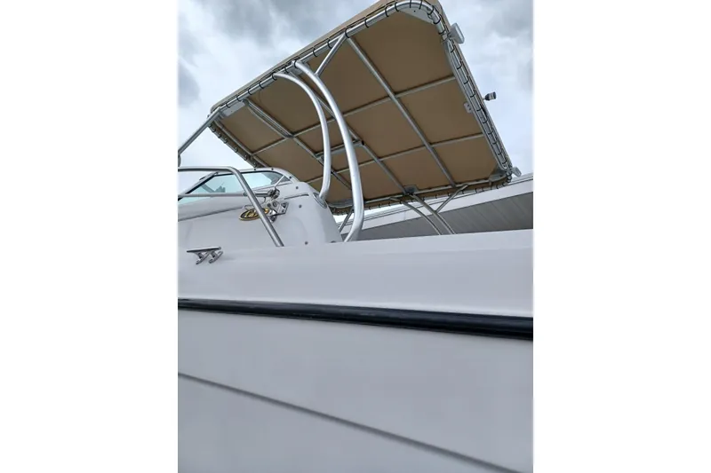 Slide: The Image of 2008 Glacier Bay 2270 Isle Runner boat with canopy against cloudy sky. - 12