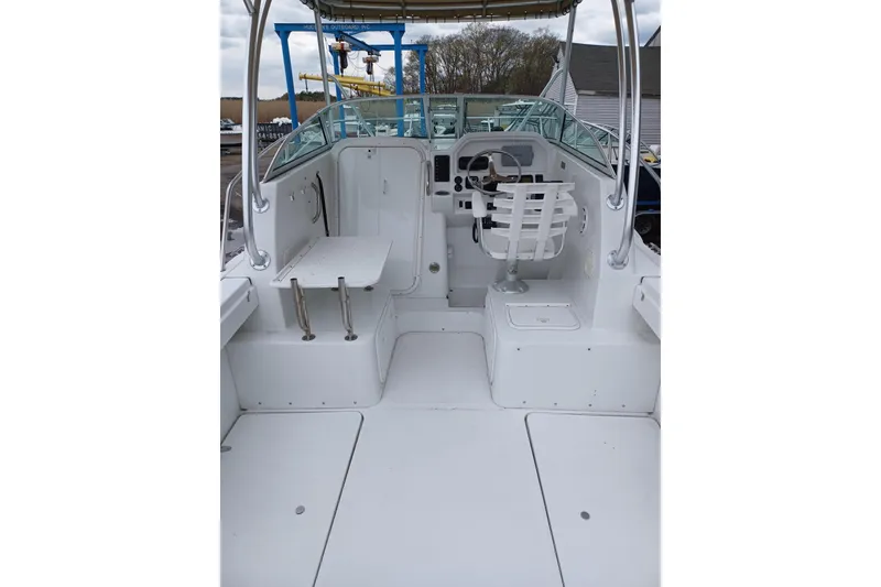 Slide: The Image of 2008 Glacier Bay 2270 Isle Runner boat interior with helm and seating area. - 6
