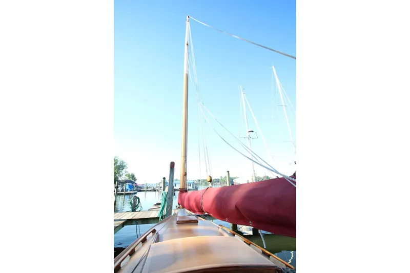 Slide: The Image of 1974 Marshall 22 Cape Cod Catboat docked with red sail cover. - 13