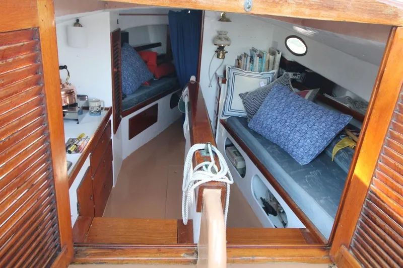 Slide: The Image of Interior of a 1974 Marshall 22 Cape Cod Catboat with cozy cabin and nautical decor. - 14