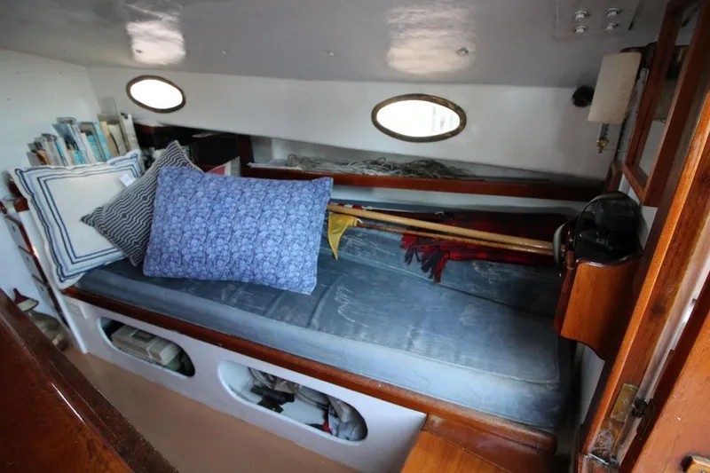 Slide: The Image of Interior of a 1974 Marshall 22 Cape Cod Catboat with cozy seating and nautical decor. - 15