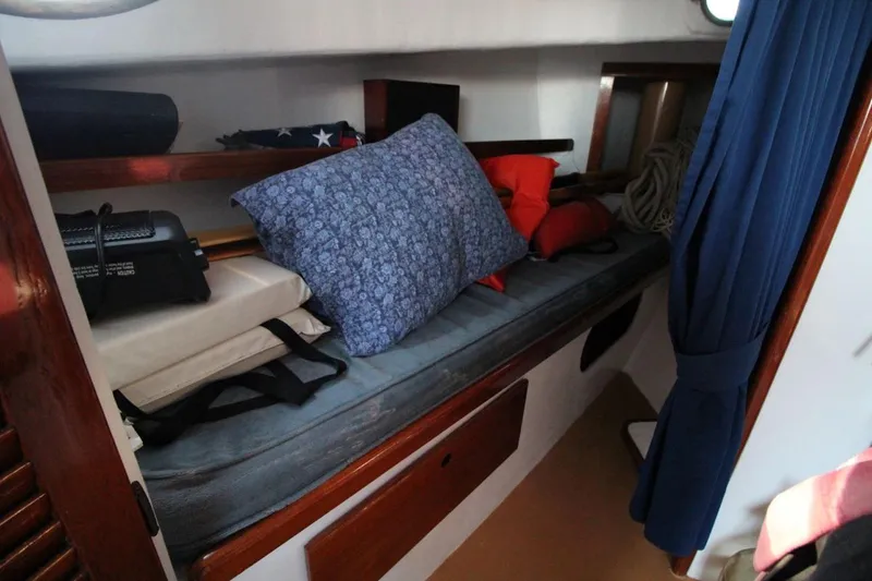 Slide: The Image of Interior cabin of a 1974 Marshall 22 Cape Cod Catboat with cushions and life jackets. - 17