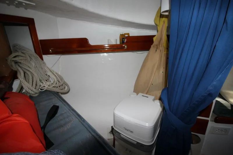 Slide: The Image of Interior of a 1974 Marshall 22 Cape Cod Catboat with ropes and portable toilet. - 18