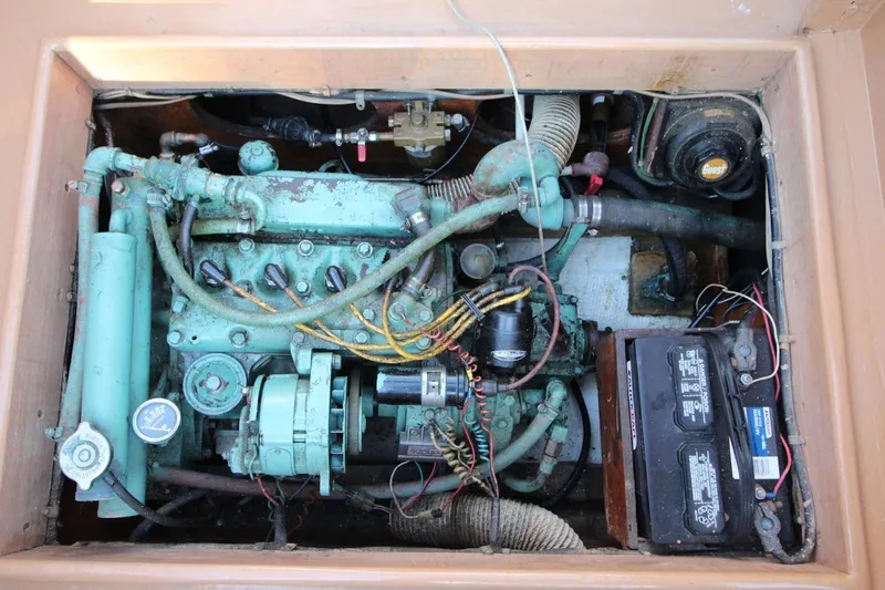 Slide: The Image of Engine compartment of a 1974 Marshall 22 Cape Cod Catboat, showing detailed mechanical components. - 19