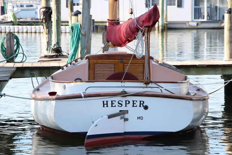 Slide: The Image of 1974 Marshall 22 Cape Cod Catboat "Hesper" docked at marina, stern view. - 6