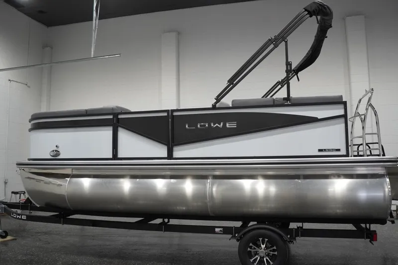 The Image of 2026 Lowe LS 190 pontoon boat in showroom, featuring sleek design and modern amenities. - 0