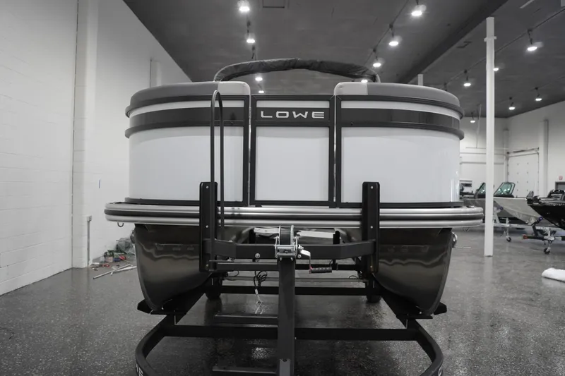 Slide: The Image of 2026 Lowe LS 190 pontoon boat in showroom, front view. - 12