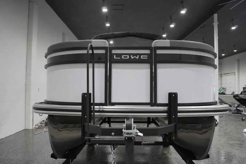 Slide: The Image of Front view of 2026 Lowe LS 190 pontoon boat in showroom. - 13