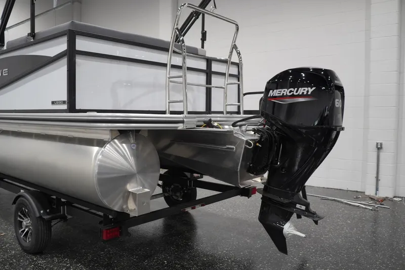 Slide: The Image of 2026 Lowe LS 190 pontoon boat with Mercury outboard motor in showroom. - 15
