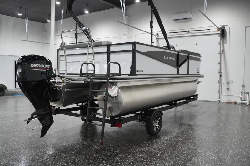 Slide: The Image of 2026 Lowe LS 190 pontoon boat with Mercury engine in showroom. - 17