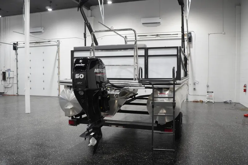 Slide: The Image of 2026 Lowe LS 190 pontoon boat with Mercury 60 GT engine in a showroom. - 18