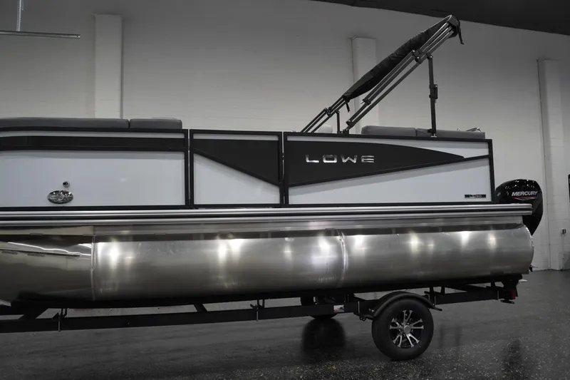Slide: The Image of 2026 Lowe LS 190 pontoon boat with Mercury engine in showroom. - 2