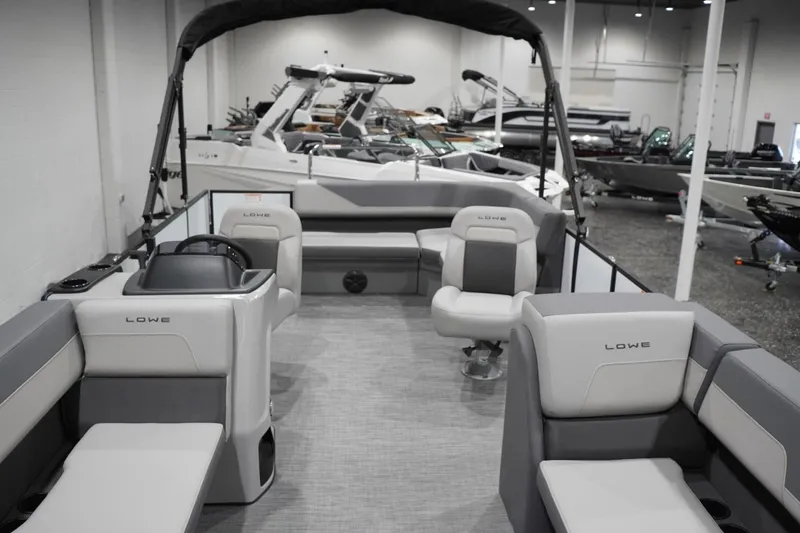 Slide: The Image of Interior view of 2026 Lowe LS 190 pontoon boat in showroom setting. - 22