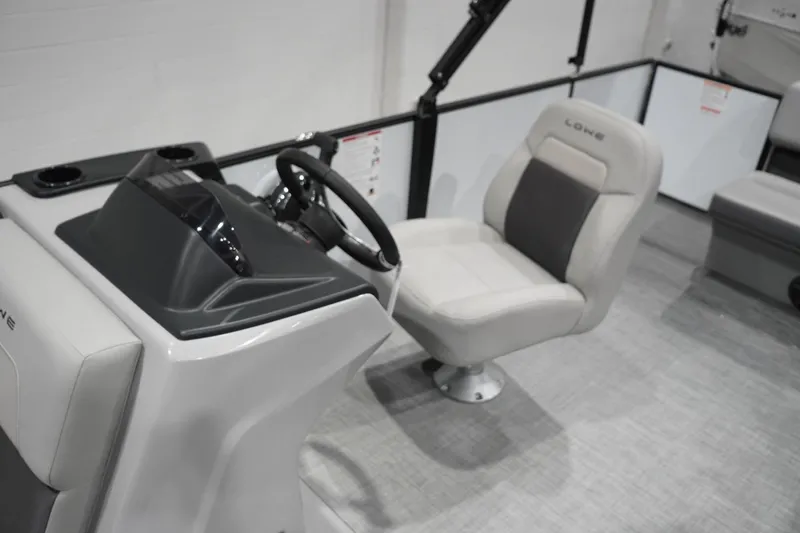 Slide: The Image of Interior of 2026 Lowe LS 190 boat featuring steering console and comfortable seating. - 25