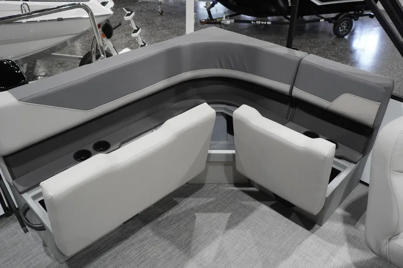 Slide: The Image of 2026 Lowe LS 190 boat interior with gray and white cushioned seating and cup holders. - 38