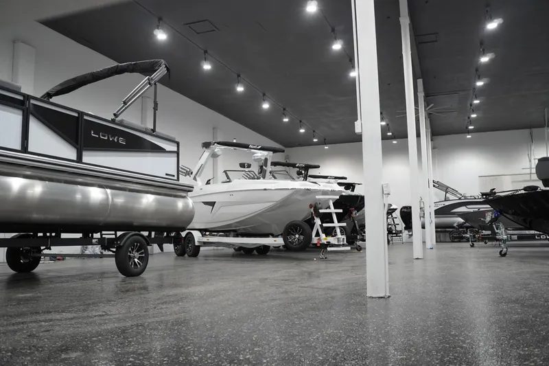 Slide: The Image of Indoor showroom displaying 2026 Lowe LS 190 boats under bright lighting. - 8