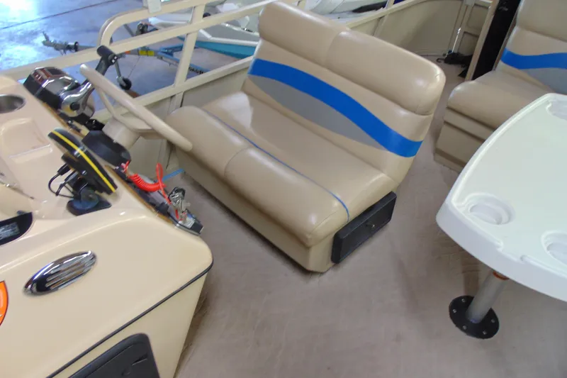 Slide: The Image of 2010 Bentley Pontoons 220 Fish interior with beige seating and steering console. - 10