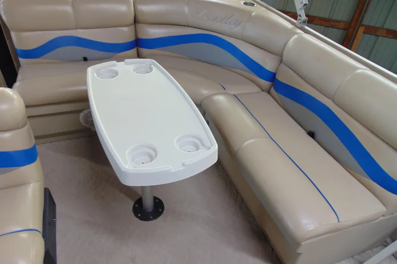 Slide: The Image of Interior of 2010 Bentley Pontoons 220 Fish with beige seating and white table. - 12