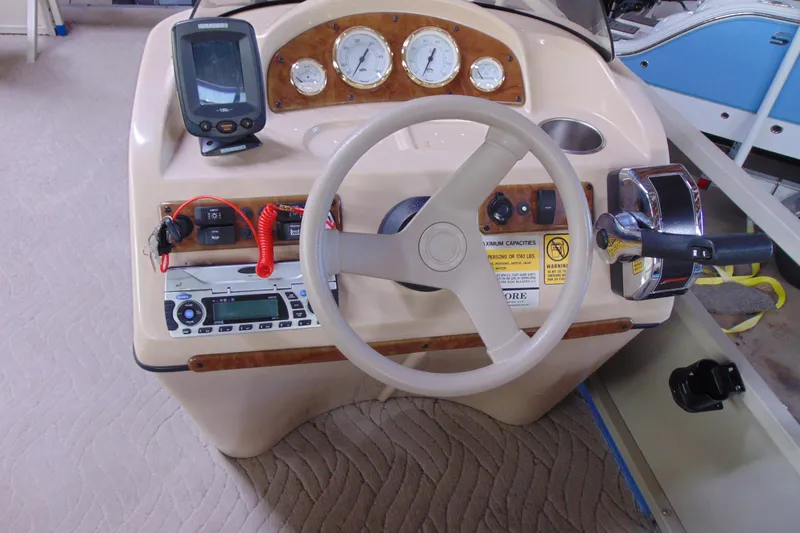 Slide: The Image of Steering console of a 2010 Bentley Pontoons 220 Fish with gauges and controls. - 13