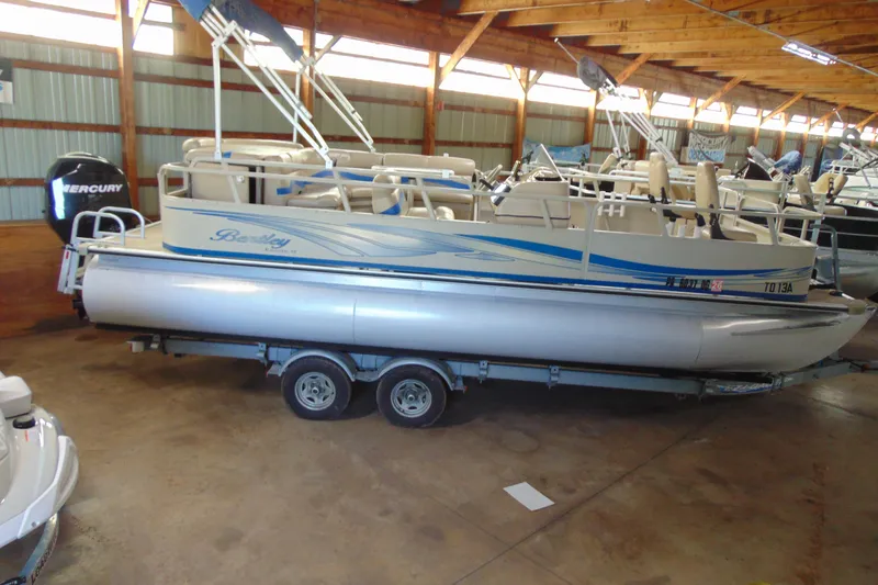 Slide: The Image of 2010 Bentley Pontoons 220 Fish boat on trailer in indoor storage. - 2