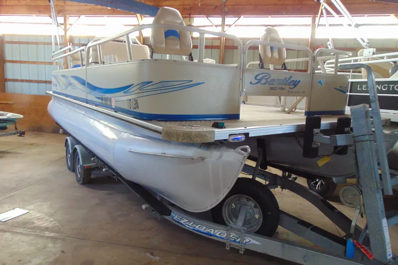 Slide: The Image of 2010 Bentley Pontoons 220 Fish on trailer in indoor storage facility. - 3