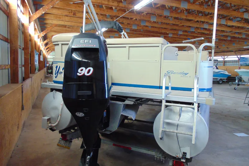 Slide: The Image of 2010 Bentley Pontoons 220 Fish boat with EFI engine in a wooden storage facility. - 4