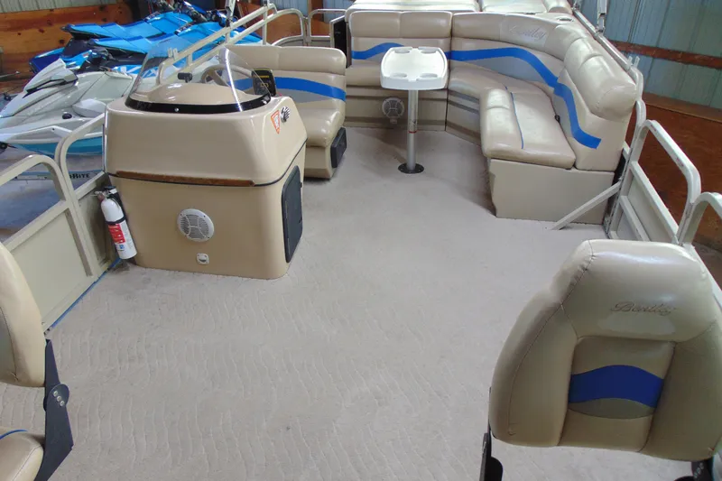 Slide: The Image of 2010 Bentley Pontoons 220 Fish interior with beige seating and steering console. - 8