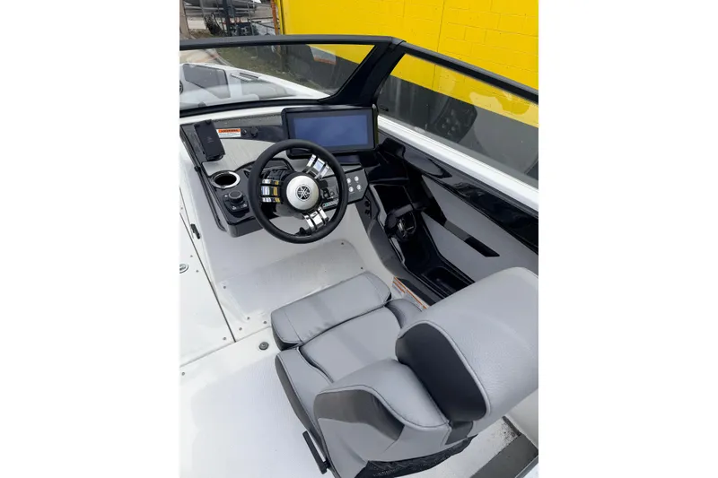 Slide: The Image of Interior of 2026 Yamaha Boats 222XD featuring modern helm. - 16
