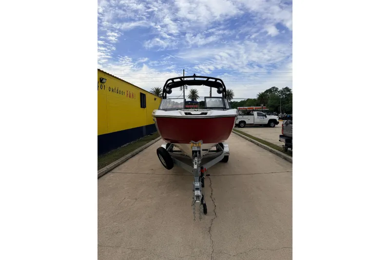 Slide: The Image of Yamaha Boats 222XD 2026 on trailer, red design, blue sky. - 6