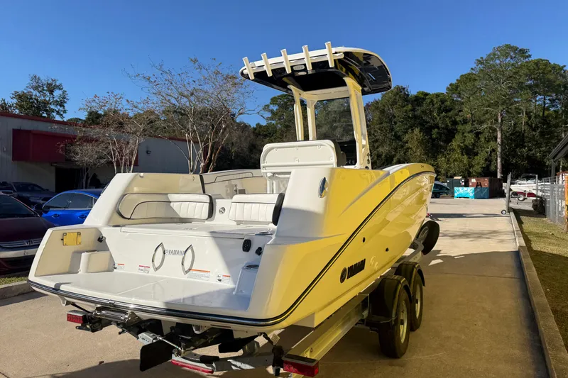 Slide: The Image of 2026 Yamaha Boats 252 FSH Sport in a driveway, showcasing sleek design and modern features. - 11