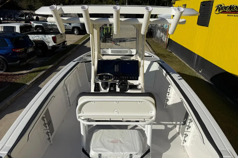 Slide: The Image of 2026 Yamaha Boats 252 FSH Sport center console with modern dashboard and rod holders. - 14
