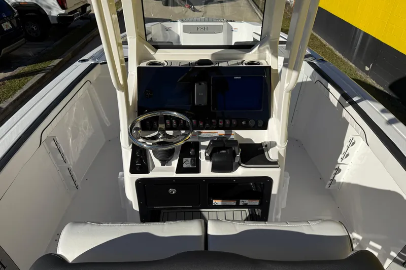 Slide: The Image of 2026 Yamaha Boats 252 FSH Sport dashboard with steering wheel and controls. - 15