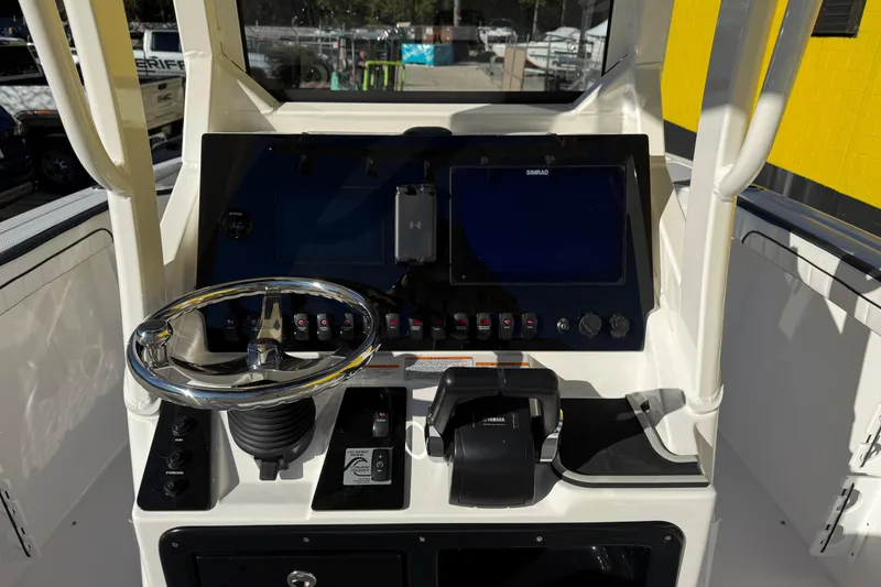 Slide: The Image of 2026 Yamaha Boats 252 FSH Sport dashboard with steering wheel and control panel. - 16