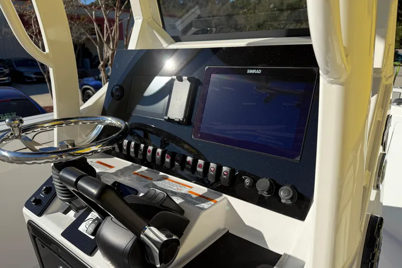 Slide: The Image of 2026 Yamaha Boats 252 FSH Sport dashboard with steering wheel and Simrad display. - 17