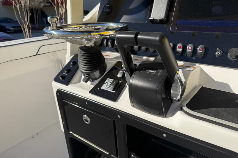 Slide: The Image of Control panel of 2026 Yamaha Boats 252 FSH Sport, featuring steering wheel and throttle controls. - 18