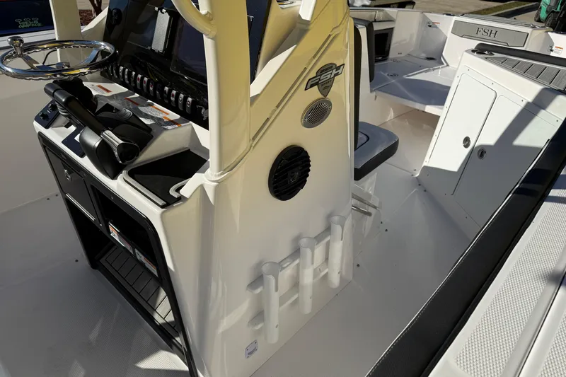 Slide: The Image of 2026 Yamaha Boats 252 FSH Sport interior with steering console and seating area. - 20