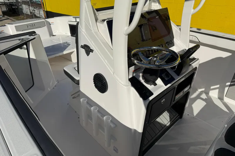 Slide: The Image of 2026 Yamaha Boats 252 FSH Sport interior with steering console and seating area. - 21